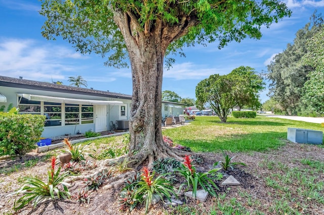 410 High Point Dr Unit C, Delray Beach, FL 33445 - view of grassy yard with central AC unit and a patio area