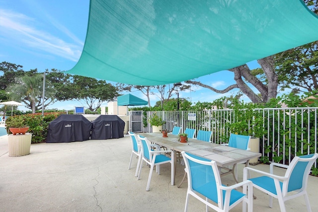 410 High Point Dr Unit C, Delray Beach, FL 33445 - view of patio / terrace featuring outdoor dining area, fence, and area for grilling