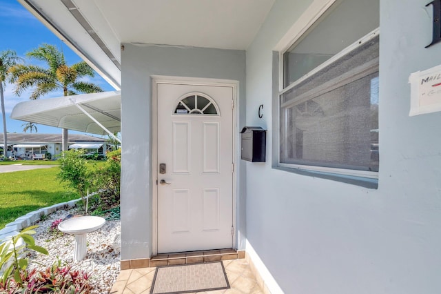 410 High Point Dr Unit C, Delray Beach, FL 33445 - view of exterior entry featuring stucco siding