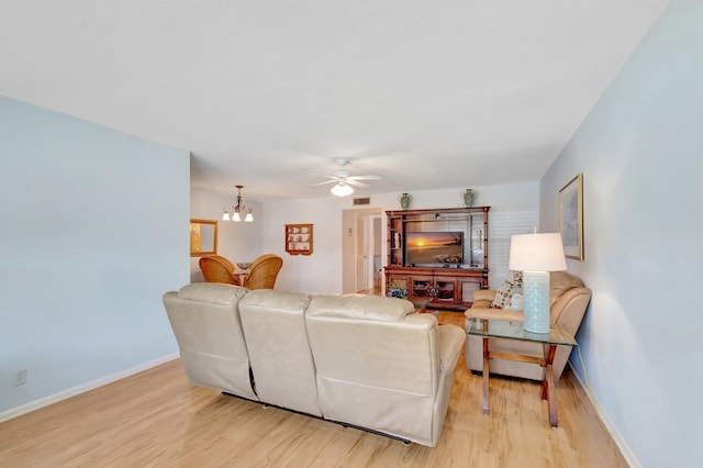 410 High Point Dr Unit C, Delray Beach, FL 33445 - living area with light wood-style floors, ceiling fan, baseboards, and a chandelier
