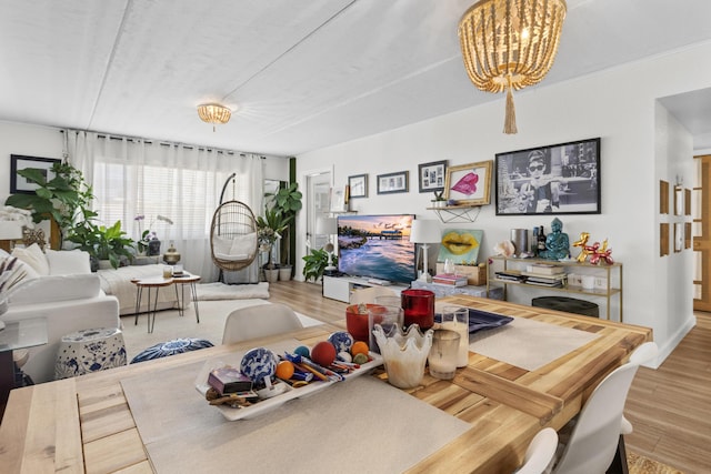 dining space with wood finished floors and a chandelier