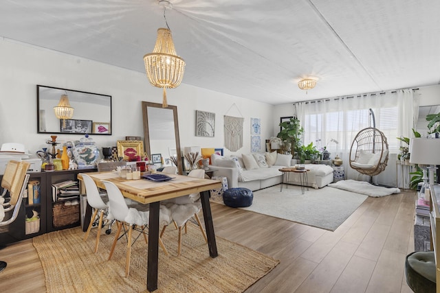 dining space featuring a chandelier and light wood finished floors