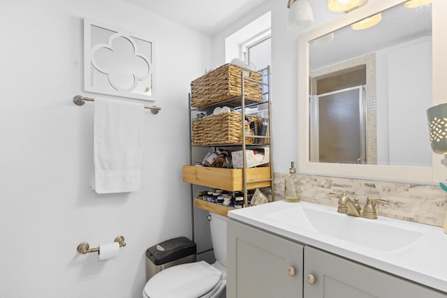 full bath featuring a stall shower, vanity, and toilet