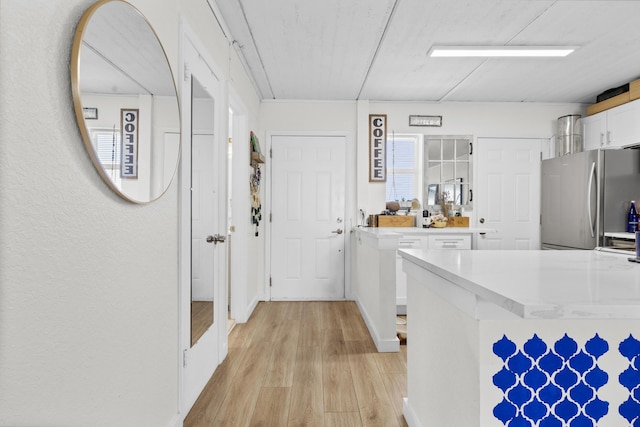 corridor featuring light wood-style floors