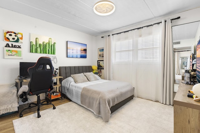 bedroom featuring a desk and wood finished floors