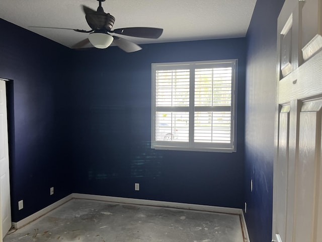 6110 46th Ln, Vero Beach, FL 32967 - spare room with baseboards, ceiling fan, and concrete flooring