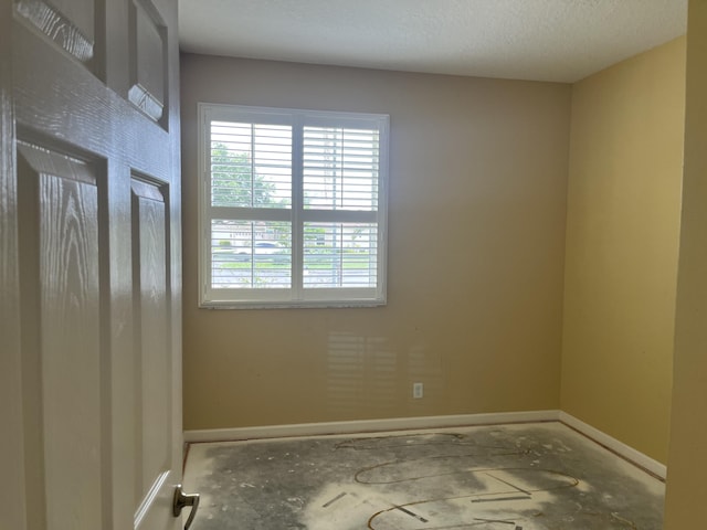 6110 46th Ln, Vero Beach, FL 32967 - empty room with baseboards and a textured ceiling