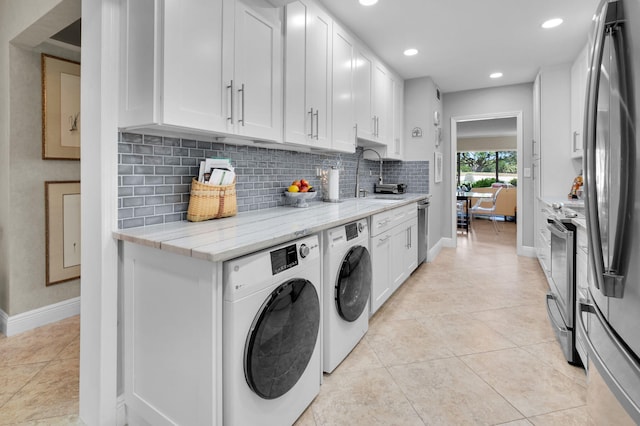 730 Greensward Ct Unit 107-J, Delray Beach, FL 33445 - washroom with baseboards, washer and clothes dryer, recessed lighting, and light tile patterned flooring