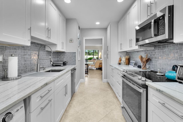 730 Greensward Ct Unit 107-J, Delray Beach, FL 33445 - kitchen with appliances with stainless steel finishes, a sink, light tile patterned floors, white cabinets, and recessed lighting