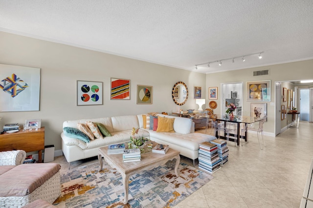 730 Greensward Ct Unit 107-J, Delray Beach, FL 33445 - living room with a textured ceiling, crown molding, light tile patterned floors, and baseboards