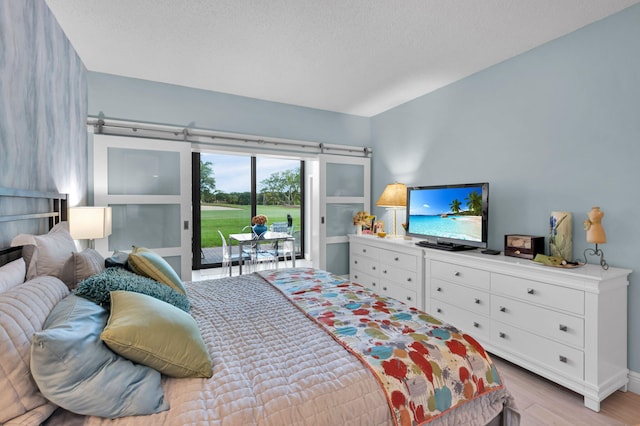 730 Greensward Ct Unit 107-J, Delray Beach, FL 33445 - bedroom featuring access to outside and light wood-type flooring