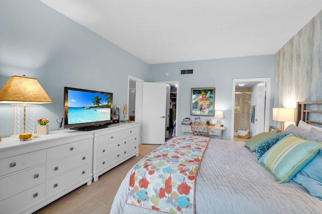 730 Greensward Ct Unit 107-J, Delray Beach, FL 33445 - bedroom with a spacious closet, light wood finished floors, ensuite bath, and a closet