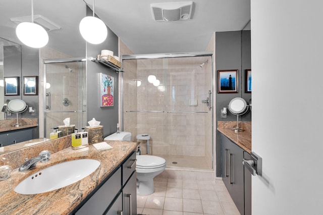 730 Greensward Ct Unit 107-J, Delray Beach, FL 33445 - bathroom with tile patterned floors, vanity, a shower stall, and toilet