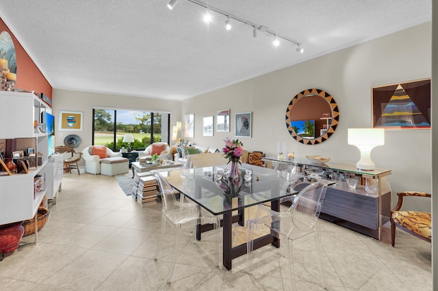 730 Greensward Ct Unit 107-J, Delray Beach, FL 33445 - dining space with a textured ceiling, rail lighting, and tile patterned flooring