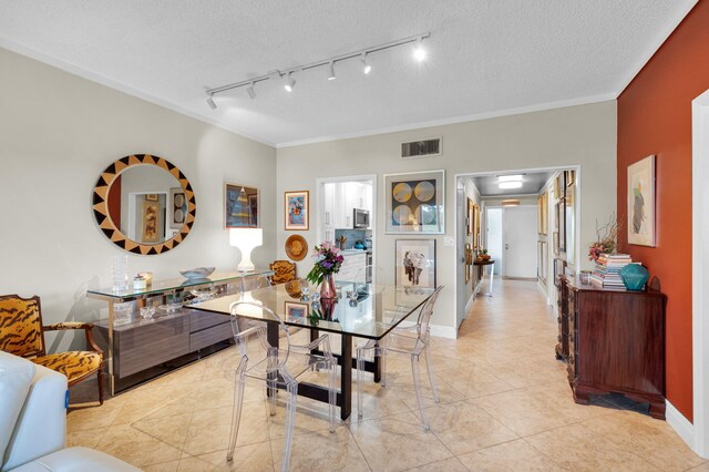 730 Greensward Ct Unit 107-J, Delray Beach, FL 33445 - living room featuring ornamental molding, light tile patterned floors, baseboards, and a textured ceiling