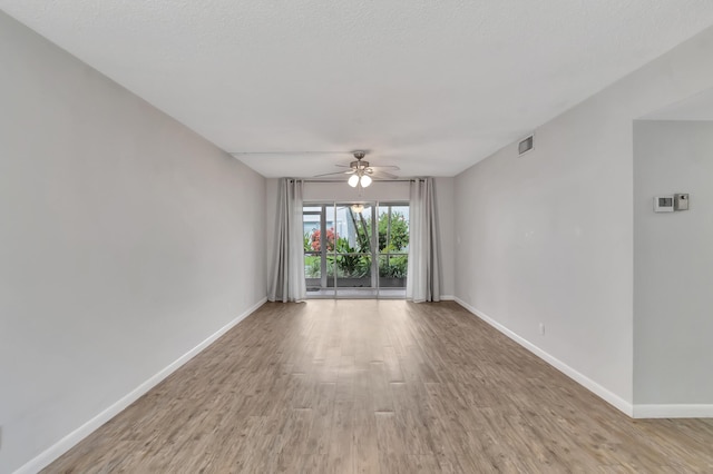 2161 NE 42nd Ct Unit 116, Lighthouse Point, FL 33064 - unfurnished room with ceiling fan, light wood-style flooring, and baseboards