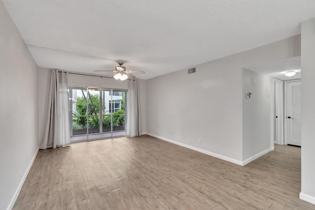 2161 NE 42nd Ct Unit 116, Lighthouse Point, FL 33064 - empty room featuring a ceiling fan, baseboards, and light wood-style flooring
