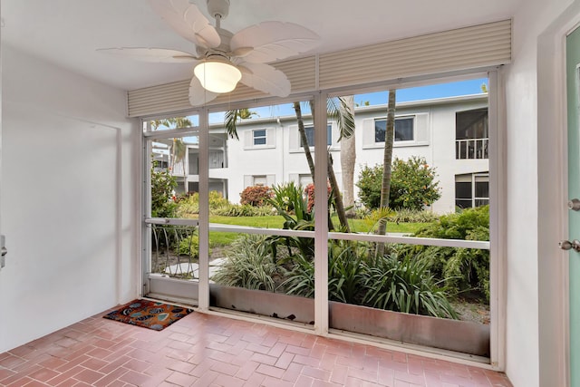 2161 NE 42nd Ct Unit 116, Lighthouse Point, FL 33064 - unfurnished sunroom featuring ceiling fan