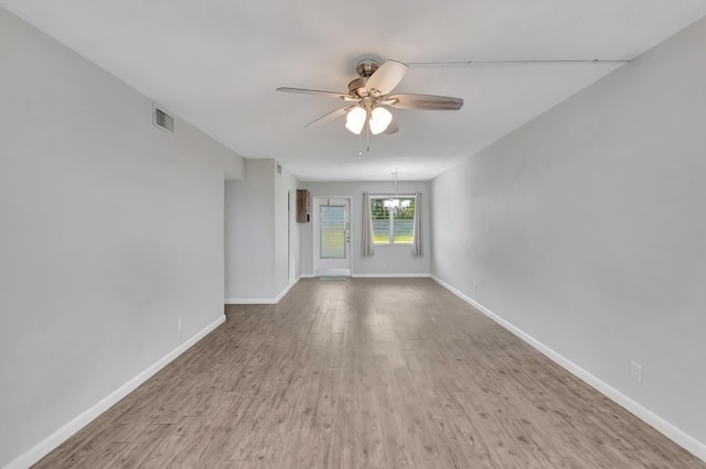 2161 NE 42nd Ct Unit 116, Lighthouse Point, FL 33064 - spare room with a ceiling fan, wood finished floors, baseboards, and a chandelier