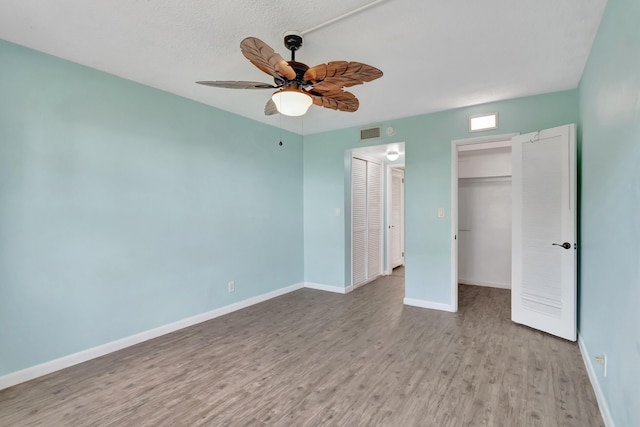 2161 NE 42nd Ct Unit 116, Lighthouse Point, FL 33064 - unfurnished bedroom featuring wood finished floors, baseboards, and ceiling fan