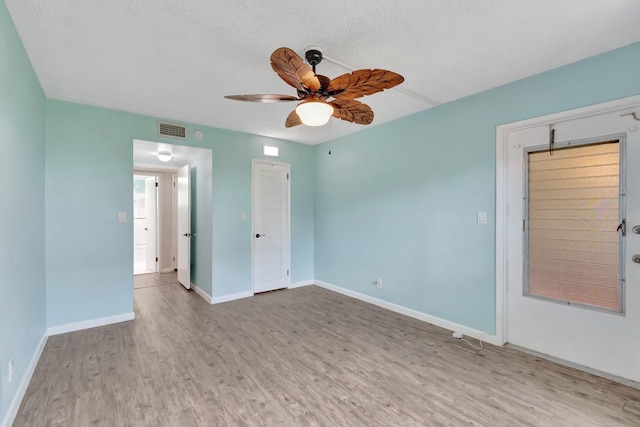 2161 NE 42nd Ct Unit 116, Lighthouse Point, FL 33064 - unfurnished room featuring wood finished floors, a ceiling fan, baseboards, and a textured ceiling
