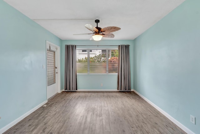 2161 NE 42nd Ct Unit 116, Lighthouse Point, FL 33064 - spare room featuring wood finished floors, a ceiling fan, and baseboards