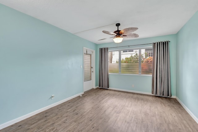 2161 NE 42nd Ct Unit 116, Lighthouse Point, FL 33064 - spare room featuring wood finished floors, baseboards, and a ceiling fan