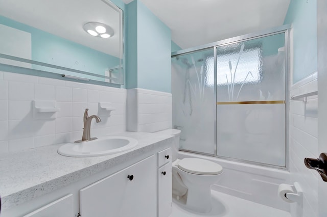 2161 NE 42nd Ct Unit 116, Lighthouse Point, FL 33064 - bathroom featuring vanity, shower / bath combination with glass door, toilet, and decorative backsplash