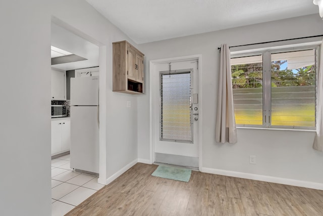 2161 NE 42nd Ct Unit 116, Lighthouse Point, FL 33064 - entryway with baseboards and light wood finished floors