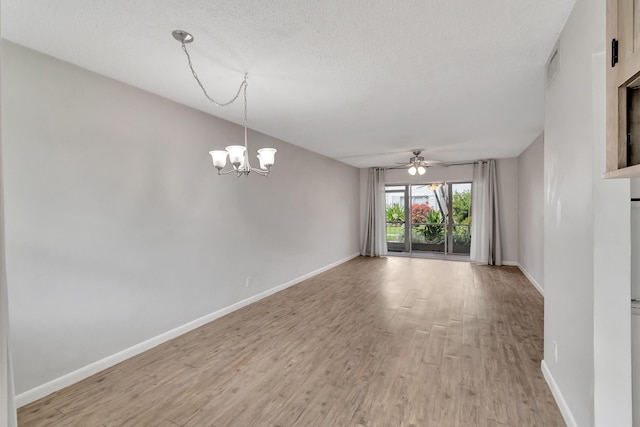2161 NE 42nd Ct Unit 116, Lighthouse Point, FL 33064 - empty room with light wood finished floors, baseboards, ceiling fan, a chandelier, and a textured ceiling