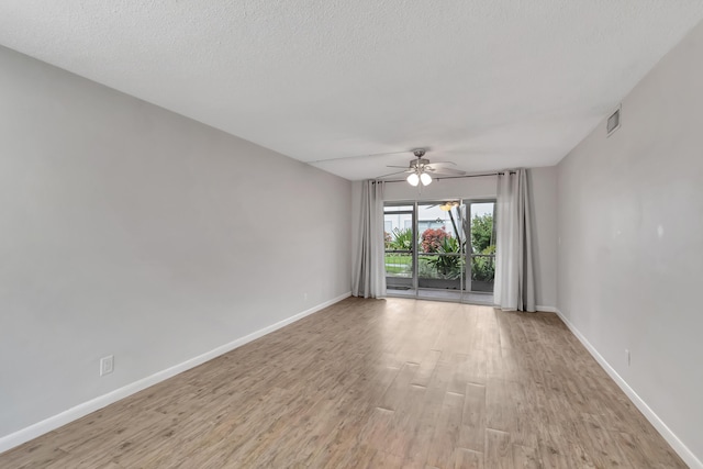 2161 NE 42nd Ct Unit 116, Lighthouse Point, FL 33064 - unfurnished room with light wood-style floors, ceiling fan, baseboards, and a textured ceiling