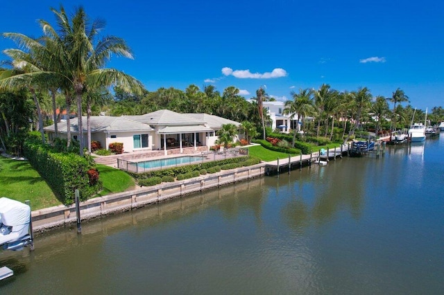 16 E High Point Rd, Sewalls Point, FL 34996 - rear view of property featuring a water view and an outdoor pool