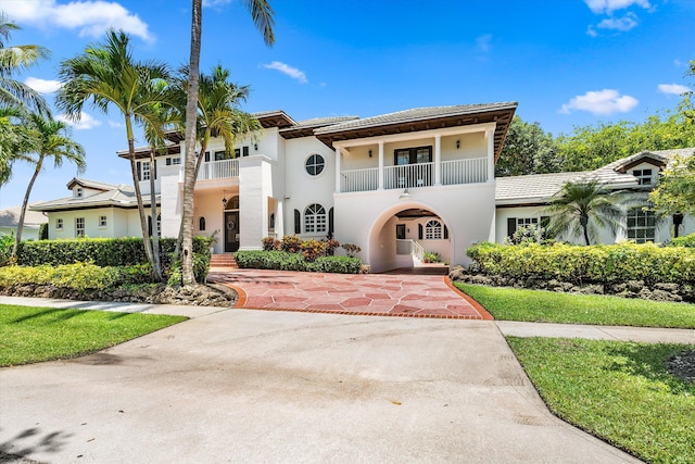 2 Firestone Cir, West Palm Beach, FL 33401 - mediterranean / spanish-style house with a balcony, stucco siding, and a tile roof