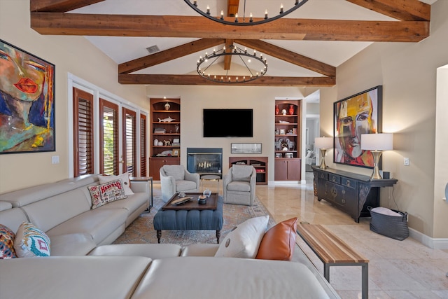 2 Firestone Cir, West Palm Beach, FL 33401 - living area featuring a chandelier, built in shelves, baseboards, and a glass covered fireplace