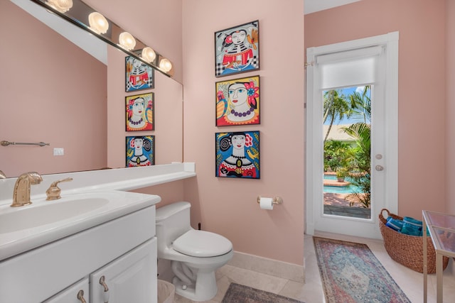 2 Firestone Cir, West Palm Beach, FL 33401 - bathroom featuring vanity, toilet, tile patterned flooring, and baseboards