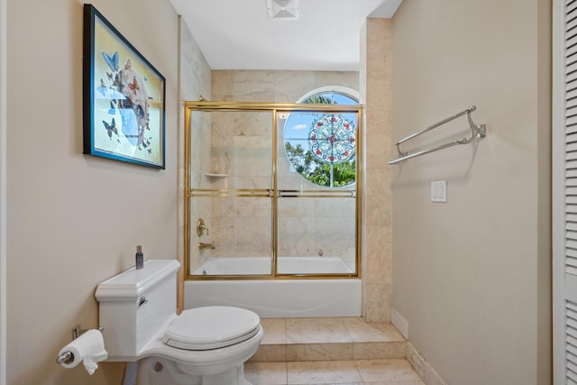 2 Firestone Cir, West Palm Beach, FL 33401 - bathroom with toilet, shower / bath combination with glass door, a closet, and tile patterned flooring
