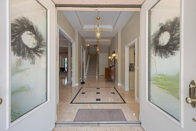 2 Firestone Cir, West Palm Beach, FL 33401 - entrance foyer featuring stairs, inlaid floor details, baseboards, a raised ceiling, and crown molding