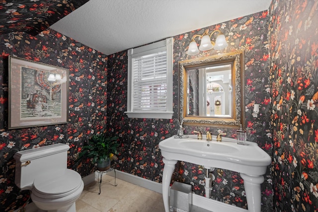 2 Firestone Cir, West Palm Beach, FL 33401 - half bathroom with baseboards, a textured ceiling, toilet, and tile patterned floors