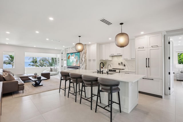 3401 S Ocean Blvd Unit 6, Highland Beach, FL 33487 - kitchen with a sink, open floor plan, recessed lighting, light countertops, and a kitchen bar