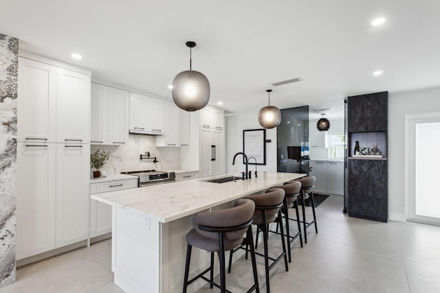 3401 S Ocean Blvd Unit 6, Highland Beach, FL 33487 - kitchen with a sink, stainless steel electric range, white cabinetry, recessed lighting, and light stone counters