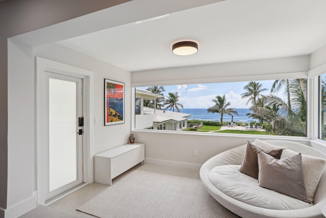 3401 S Ocean Blvd Unit 6, Highland Beach, FL 33487 - sitting room featuring a water view, light colored carpet, and baseboards