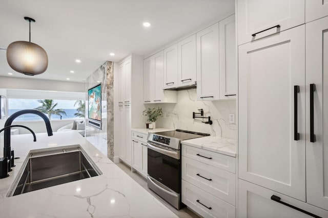 3401 S Ocean Blvd Unit 6, Highland Beach, FL 33487 - kitchen featuring electric stove, a sink, white cabinetry, recessed lighting, and light stone counters