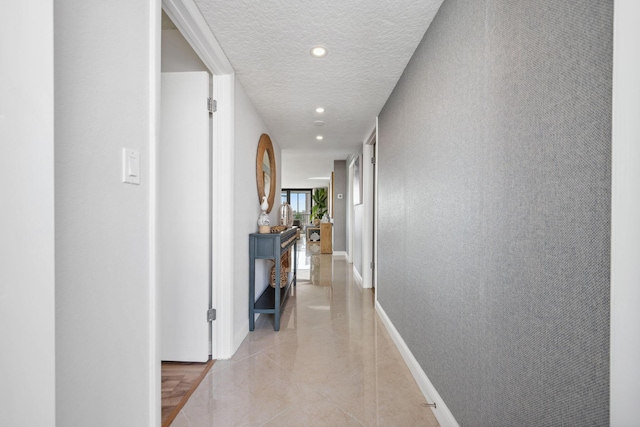 1627 Riverview Rd Unit 409, Deerfield Beach, FL 33441 - hall with recessed lighting, a textured ceiling, light tile patterned floors, and baseboards