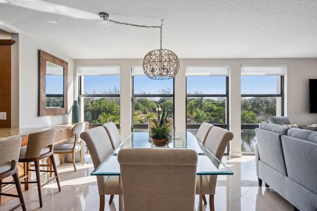 1627 Riverview Rd Unit 409, Deerfield Beach, FL 33441 - dining room featuring light tile patterned floors, a textured ceiling, and a chandelier