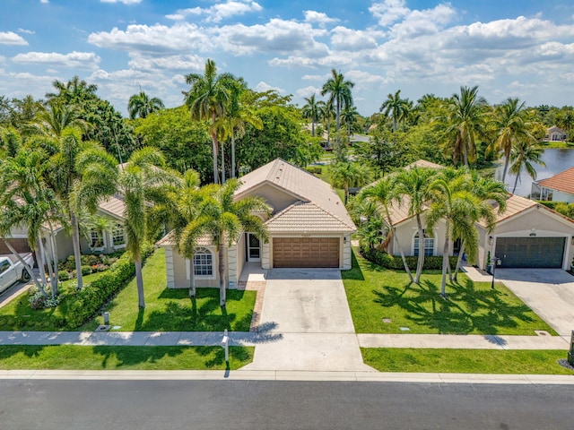 1833 Barnstable Rd, Wellington, FL 33414 - view of front of house with a tile roof, a front lawn, driveway, stucco siding, and an attached garage