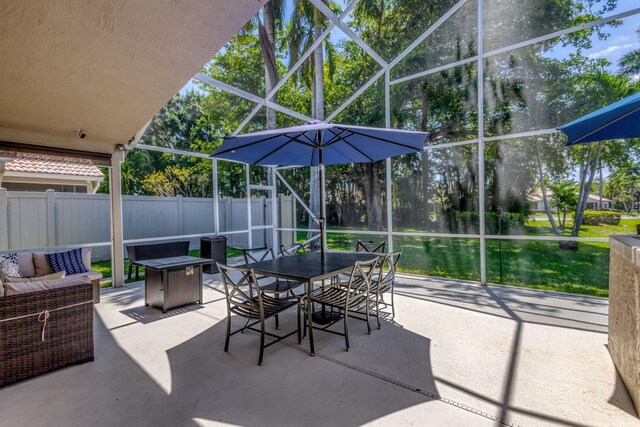 1833 Barnstable Rd, Wellington, FL 33414 - view of patio featuring glass enclosure, outdoor dining area, and an outdoor living space with a fire pit