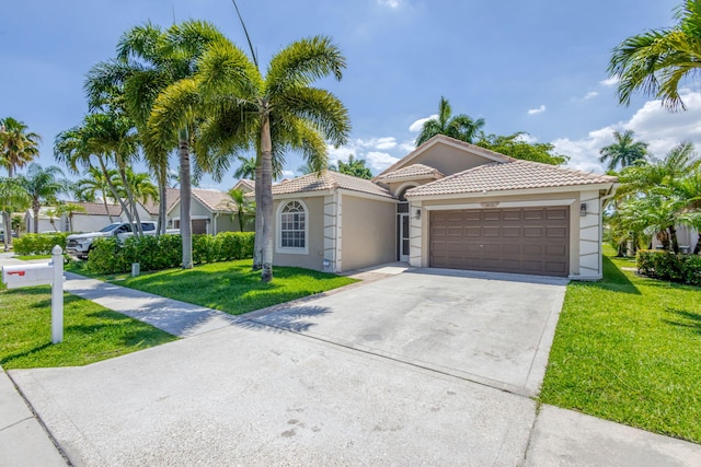 1833 Barnstable Rd, Wellington, FL 33414 - mediterranean / spanish-style home featuring a garage, concrete driveway, stucco siding, and a front lawn