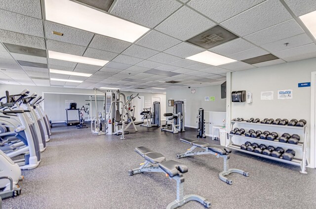 1833 Barnstable Rd, Wellington, FL 33414 - workout area featuring a paneled ceiling and baseboards