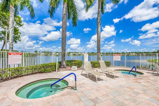 1833 Barnstable Rd, Wellington, FL 33414 - view of pool with a community hot tub, a water view, a patio, and a swimming pool
