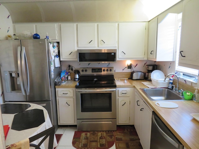9233 SW 8th St Unit 207, Boca Raton, FL 33428 - kitchen with appliances with stainless steel finishes, a sink, and white cabinets